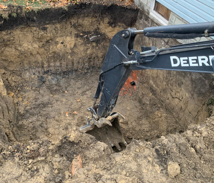 excavation in Westville; excavator arm digging in dirt