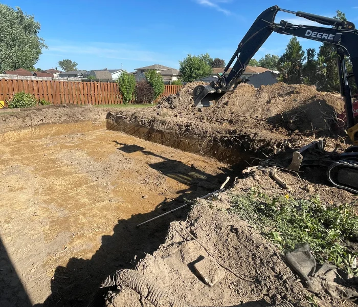 wideshot of an excavator digging a hole in the ground