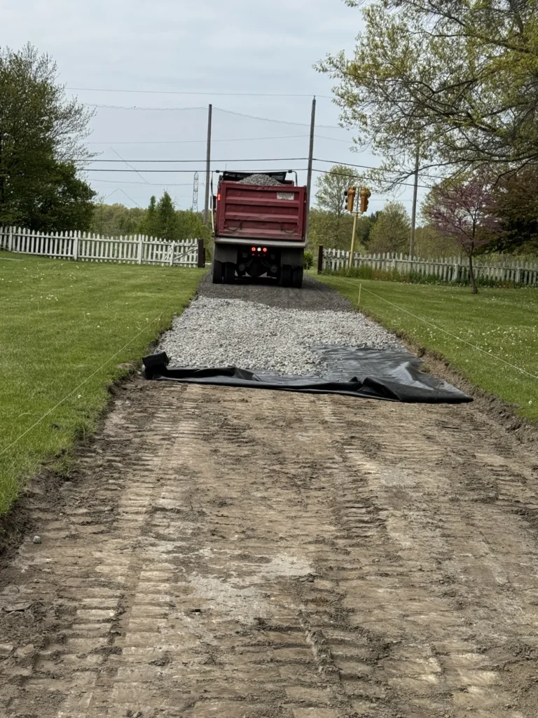 Dump truck leaving the scene of a brand new driveway install